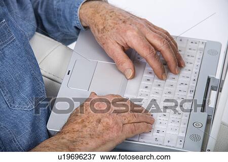 Stock Photo - Senior man using laptop. Fotosearch