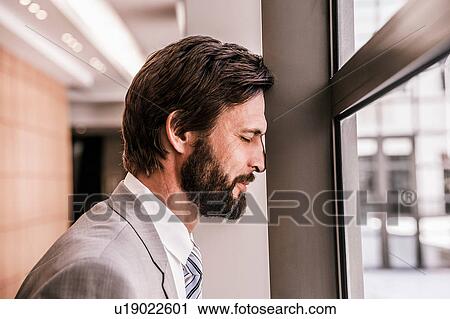 Side view of bearded businessman, eyes closed, head leaning against window frame View Large Photo Image Stock Image - Side view of bearded businessman, eyes closed, head leaning against window frame. Fotosearch