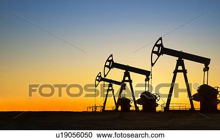 Silhouette of oil wells in desert at sunset, Texas, USA View Large Photo Image Stock Image - Silhouette of oil wells in desert at sunset, Texas, USA. Fotosearch