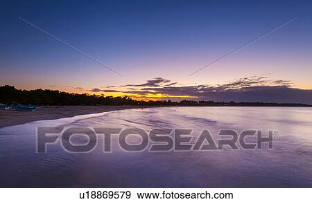 Stock Photo - Silhouetted sunset at beach, Dominican Republic, The Caribbean. Fotosearch