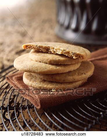 Stock Image - Stack of poppy seed shortbread biscuits, close-up. Fotosearch