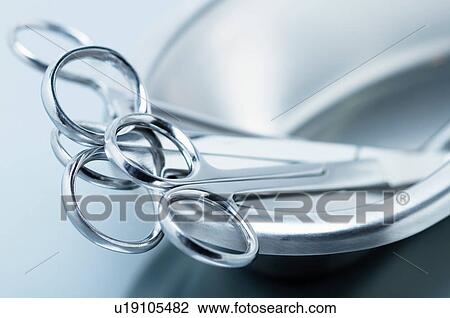 Stock Image - Stainless steel surgical instruments in kidney dish. Fotosearch