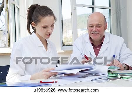 Stock Photograph - Student scientist with senior teacher. Fotosearch