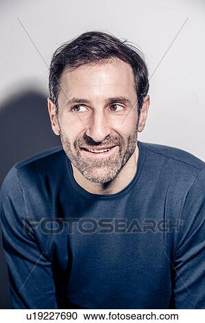 Studio portrait of happy bearded man looking sideways View Large Photo Image Stock Image - Studio portrait of happy bearded man looking sideways. Fotosearch