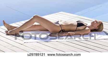 Sunbathing woman View Large Photo Image Stock Image - Sunbathing woman. Fotosearch