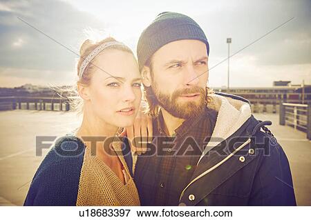 Sunlit portrait of mid adult couple on rooftop parking lot View Large Photo Image Stock Photo - Sunlit portrait of mid adult couple on rooftop parking lot. Fotosearch