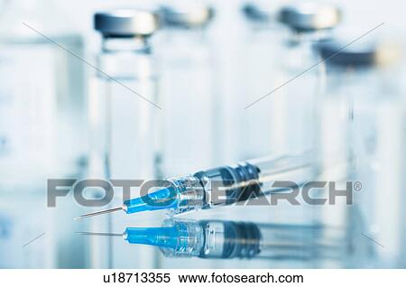 Stock Photography - Syringe. Disposable plastic medical syringe surrounded by sealed medication vials. Fotosearch