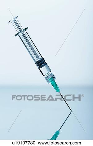Syringe with needle standing upright View Large Photo Image Stock Image - Syringe with needle standing upright. Fotosearch