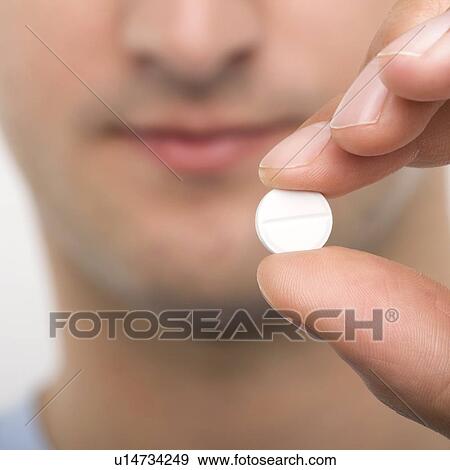 Stock Photo - Taking a tablet. Fotosearch