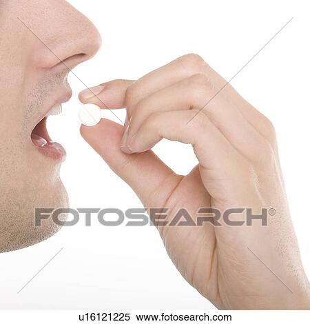 Stock Photography - Taking a tablet. Fotosearch