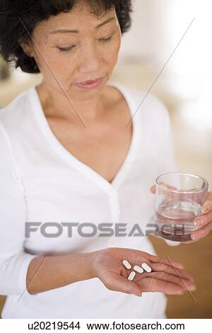 Taking pills View Large Photo Image Picture - Taking pills. Fotosearch