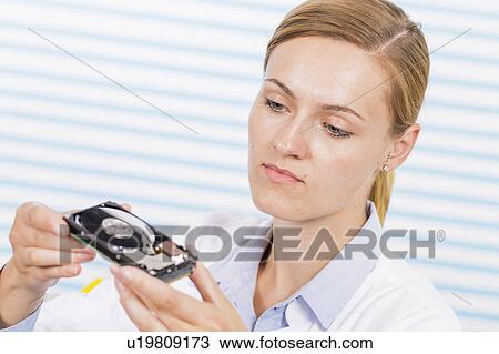 Technician holding hard disc drive View Large Photo Image Stock Image - Technician holding hard disc drive. Fotosearch