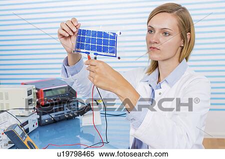 Stock Photography - Technician holding thin film solar cells. Fotosearch