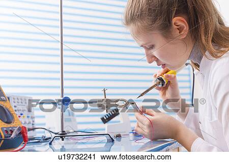 Technician soldering wires in lab View Large Photo Image Stock Image - Technician soldering wires in lab. Fotosearch