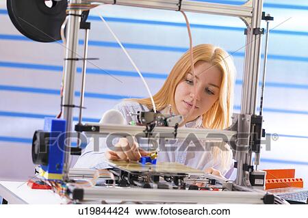 Picture - Technician using 3d printer. Fotosearch