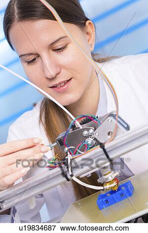 Stock Photo - Technician using 3d printer. Fotosearch