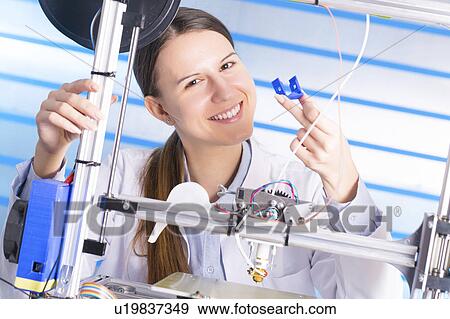 Stock Photo - Technician using 3d printer. Fotosearch
