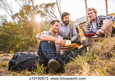 Three men frying breakfast on camping stove in forest, Deer Park, Cape Town, South Africa View Large Photo Image Stock Image - Three men frying breakfast on camping stove in forest, Deer Park, Cape Town, South Africa. Fotosearch