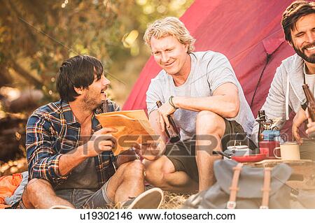 Three men reading map whilst camping in forest, Deer Park, Cape Town, South Africa View Large Photo Image Stock Photograph - Three men reading map whilst camping in forest, Deer Park, Cape Town, South Africa. Fotosearch