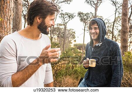 Two men drinking coffee and chatting in forest, Deer Park, Cape Town, South Africa View Large Photo Image Stock Image - Two men drinking coffee and chatting in forest, Deer Park, Cape Town, South Africa. Fotosearch