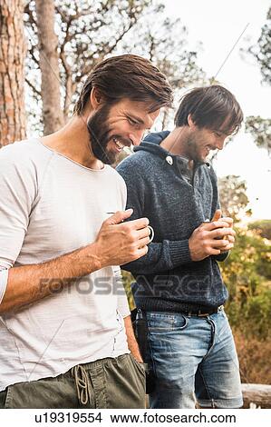 Picture - Two men drinking coffee in forest, Deer Park, Cape Town, South Africa. Fotosearch