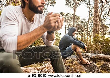 Two men drinking coffee whilst sitting on fallen tree, Deer Park, Cape Town, South Africa View Large Photo Image Stock Image - Two men drinking coffee whilst sitting on fallen tree, Deer Park, Cape Town, South Africa. Fotosearch