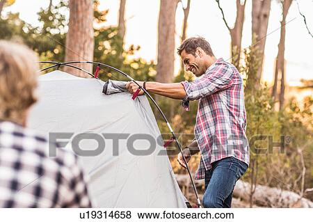 Two men erecting tent in forest, Deer Park, Cape Town, South Africa View Large Photo Image Stock Photo - Two men erecting tent in forest, Deer Park, Cape Town, South Africa. Fotosearch