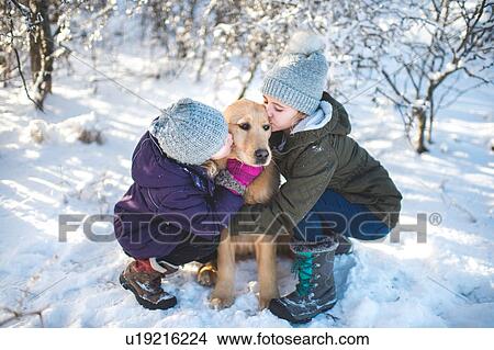 Two young girls, hugging dog, in snowy landscape View Large Photo Image Picture - Two young girls, hugging dog, in snowy landscape. Fotosearch