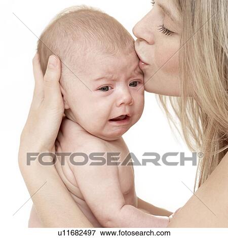 Upset baby being soothed by her mother View Large Photo Image Stock Photo - Upset baby being soothed by her mother. Fotosearch