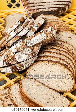 Stock Image - Variety of sliced bread in crate. Fotosearch