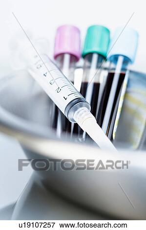 Vials of blood and syringe in kidney dish View Large Photo Image Stock Photo - Vials of blood and syringe in kidney dish. Fotosearch