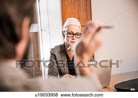 View over shoulder of businesswoman in meeting View Large Photo Image Stock Photo - View over shoulder of businesswoman in meeting. Fotosearch