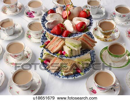 Vintage tea cups and sandwiches on cakestand prepared for afternoon tea View Large Photo Image Stock Photo - Vintage tea cups and sandwiches on cakestand prepared for afternoon tea. Fotosearch
