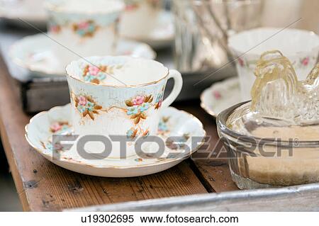 Stock Photography - Vintage teacup and saucer on wooden table. Fotosearch