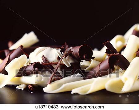 Stock Image - White, dark and milk chocolate curls. Fotosearch