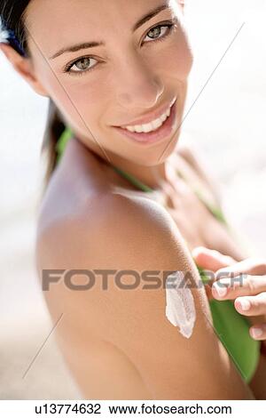 Woman applying sunscreen View Large Photo Image Stock Image - Woman applying sunscreen. Fotosearch