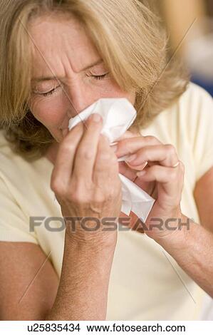 Woman blowing her nose View Large Photo Image Picture - Woman blowing her nose. Fotosearch