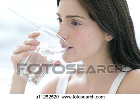 Woman drinking a glass of water View Large Photo Image Stock Image - Woman drinking a glass of water. Fotosearch