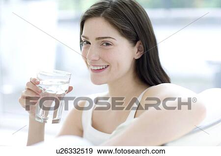 Woman drinking a glass of water View Large Photo Image Stock Photo - Woman drinking a glass of water. Fotosearch