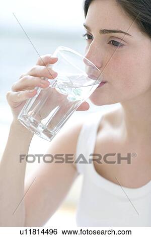 Stock Photograph - Woman drinking a glass of water. Fotosearch