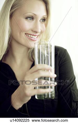 Woman drinking a glass of water View Large Photo Image Stock Photography - Woman drinking a glass of water. Fotosearch