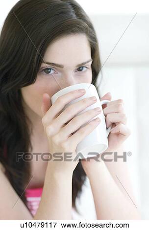 Woman drinking a hot drink View Large Photo Image Stock Photo - Woman drinking a hot drink. Fotosearch