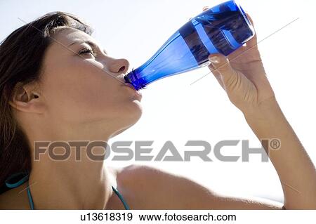 Woman drinking View Large Photo Image Stock Photo - Woman drinking. Fotosearch