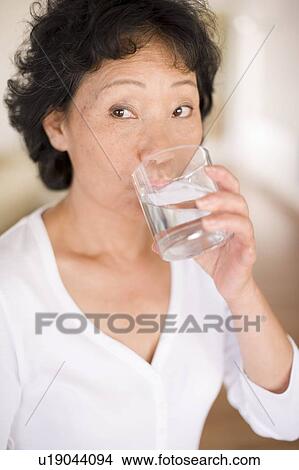 Woman drinking water View Large Photo Image Picture - Woman drinking water. Fotosearch