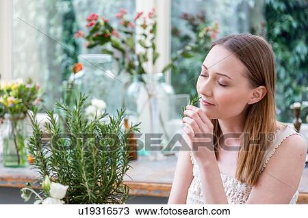 Woman, eyes closed smelling rosemary plant View Large Photo Image Stock Image - Woman, eyes closed smelling rosemary plant. Fotosearch