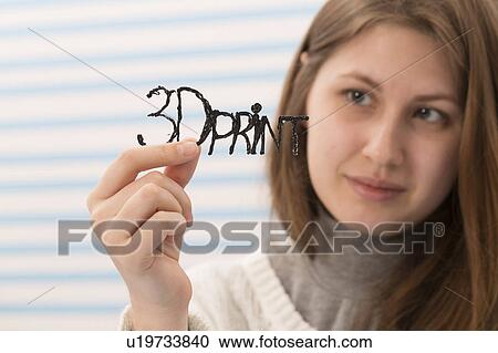 Stock Image - Woman holding a 3D printed sample. Fotosearch