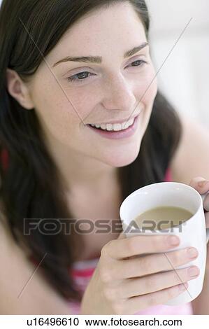 Stock Image - Woman holding a hot drink. Fotosearch