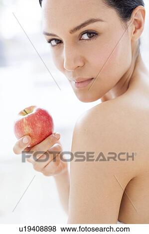 Stock Photo - Woman holding an apple. Fotosearch