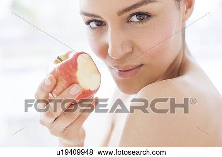 Stock Photo - Woman holding an apple. Fotosearch