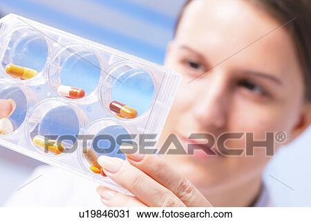 Woman holding tablets View Large Photo Image Stock Image - Woman holding tablets. Fotosearch
